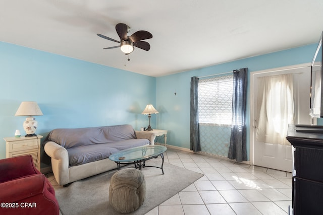 living room with light tile patterned flooring, baseboards, and ceiling fan