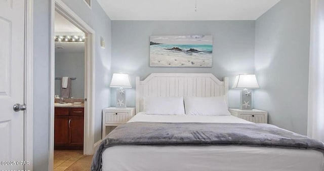 bedroom featuring a sink and ensuite bath