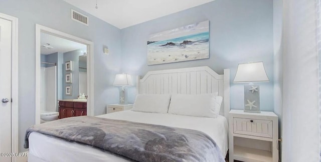 bedroom featuring visible vents and ensuite bath