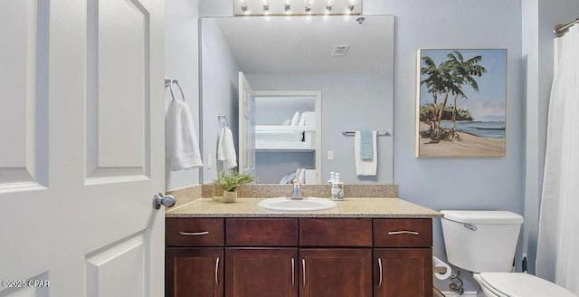 bathroom featuring vanity and toilet