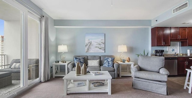 living area featuring visible vents and light colored carpet