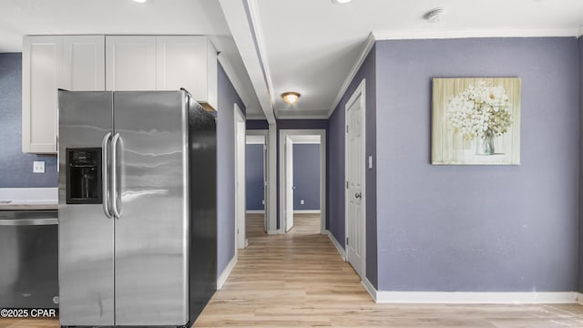 hall with light wood-style flooring, baseboards, and ornamental molding