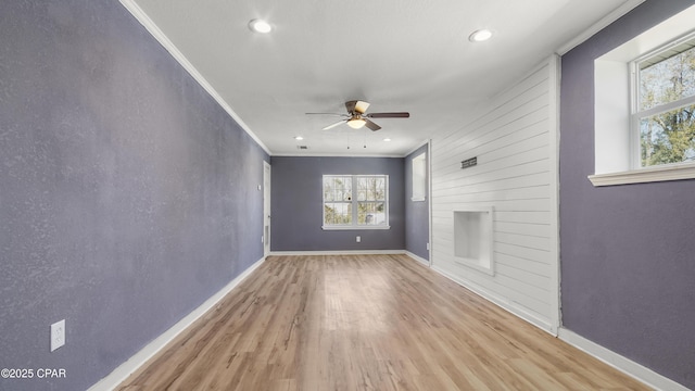 unfurnished living room featuring crown molding, baseboards, ceiling fan, recessed lighting, and wood finished floors