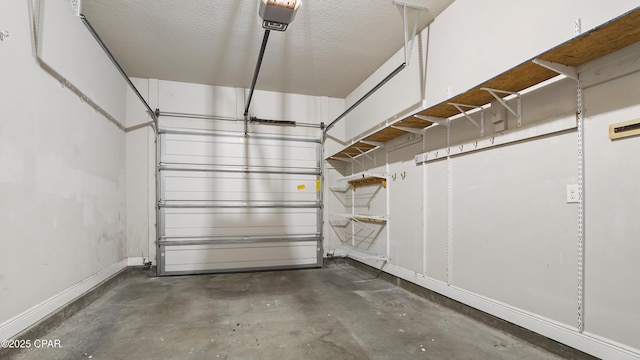 garage with a garage door opener and baseboards