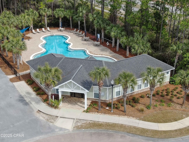 community pool with fence and a patio area