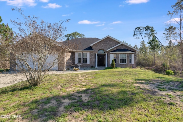 view of front of house featuring a garage, driveway, brick siding, and a front yard