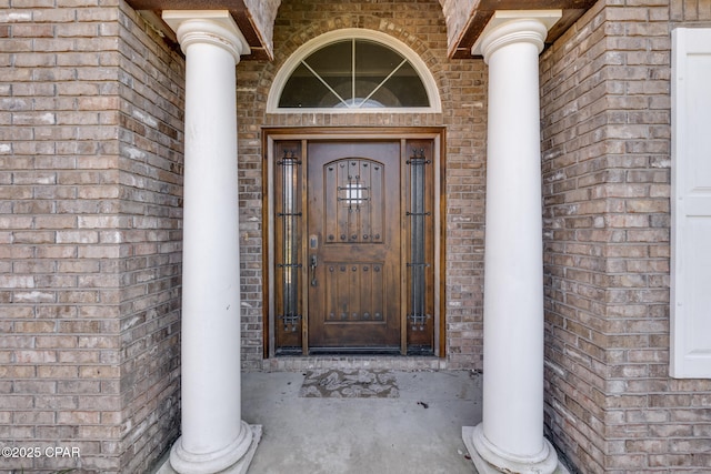 property entrance featuring brick siding