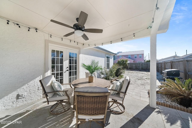 view of patio / terrace with a fenced backyard, outdoor dining space, french doors, and a ceiling fan