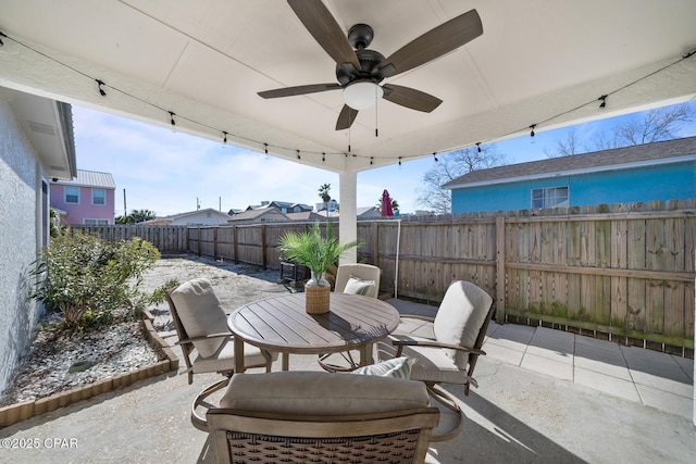 view of patio featuring a fenced backyard, a ceiling fan, and outdoor dining space