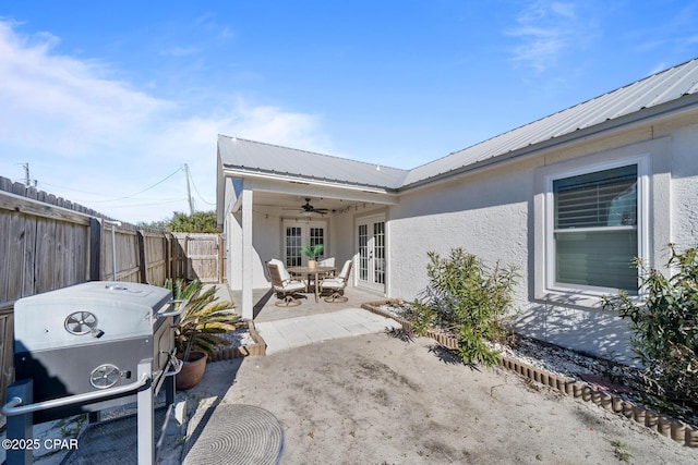view of patio featuring ceiling fan, french doors, a fenced backyard, and grilling area