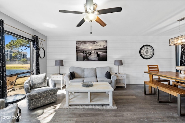 living room with wood finished floors and a ceiling fan