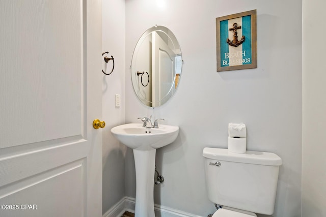 bathroom with toilet and a sink