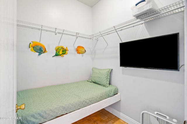 tiled bedroom featuring baseboards