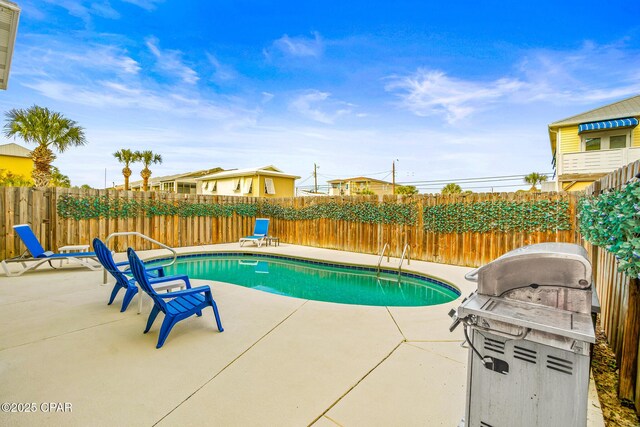 view of swimming pool with a patio area, a fenced in pool, a fenced backyard, and a grill