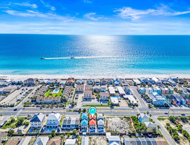 birds eye view of property with a beach view, a water view, and a residential view