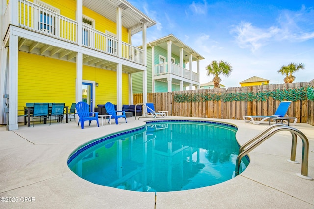 view of pool with a patio area, fence, and a fenced in pool