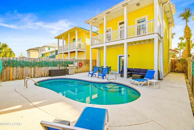 view of pool featuring a patio area, a fenced in pool, an outdoor hangout area, and fence