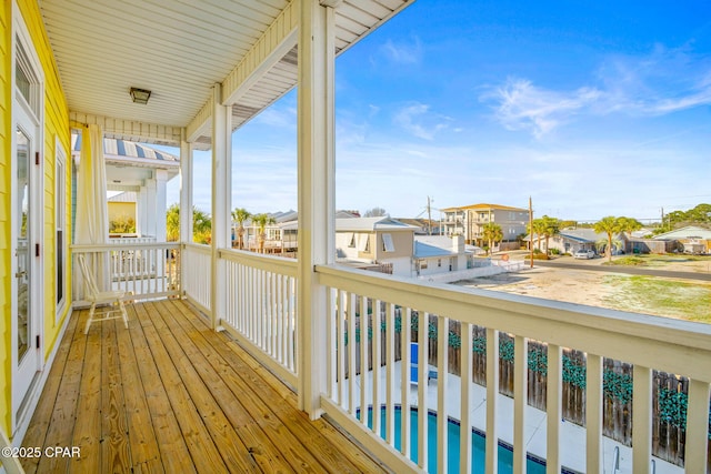 deck featuring an outdoor pool and a residential view