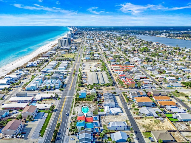 birds eye view of property featuring a beach view and a water view