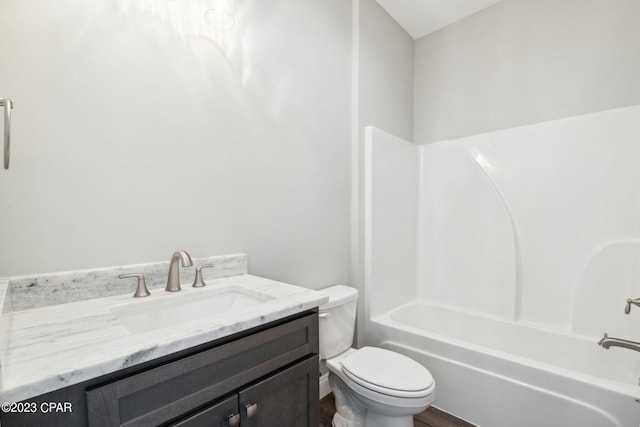 bathroom featuring toilet, vanity, and washtub / shower combination