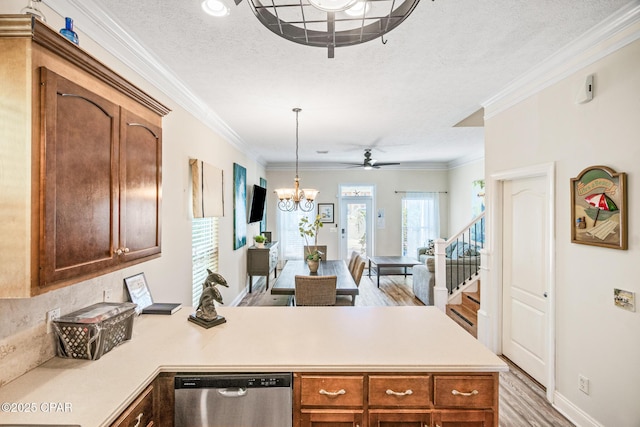 kitchen featuring stainless steel dishwasher, a peninsula, crown molding, and light countertops