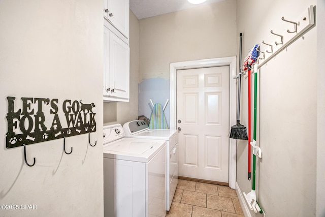 clothes washing area with cabinet space and separate washer and dryer