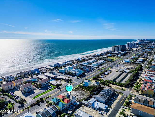 drone / aerial view featuring a beach view and a water view