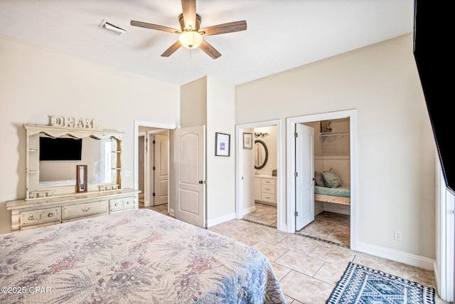 bedroom with visible vents, ceiling fan, baseboards, ensuite bathroom, and light tile patterned flooring