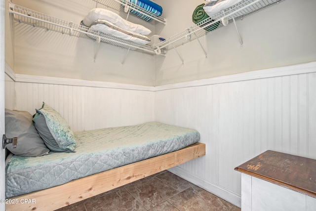 bedroom featuring wainscoting