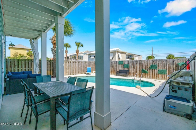 view of swimming pool with outdoor dining area, a patio area, a fenced in pool, and a fenced backyard