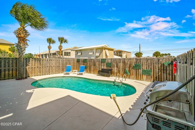 view of swimming pool featuring a patio, a fenced in pool, a fenced backyard, and a grill