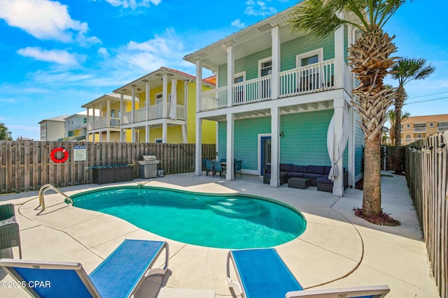 view of swimming pool with a fenced in pool, a patio, a grill, and a fenced backyard