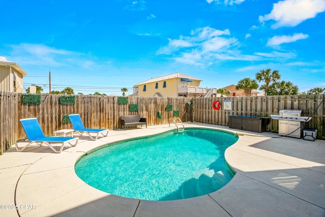 view of pool with a fenced in pool, a grill, a fenced backyard, and a patio area