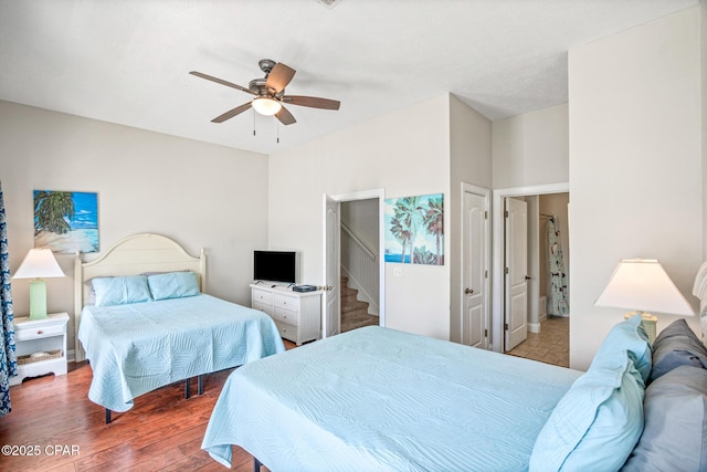 bedroom featuring connected bathroom, ceiling fan, and wood finished floors