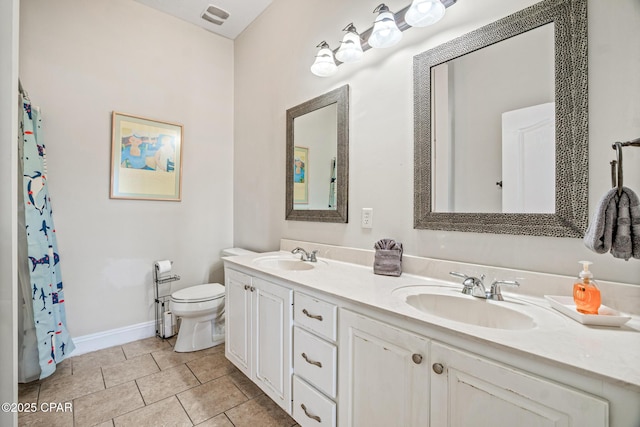 full bathroom featuring tile patterned floors, double vanity, toilet, and a sink