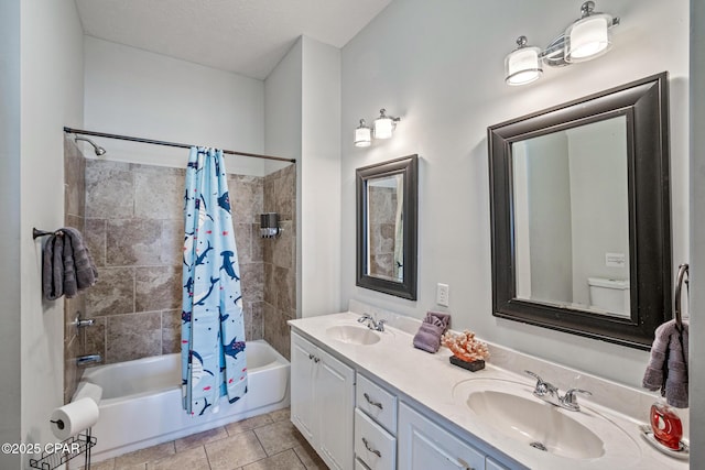 full bath featuring a sink, double vanity, shower / tub combo, and tile patterned floors