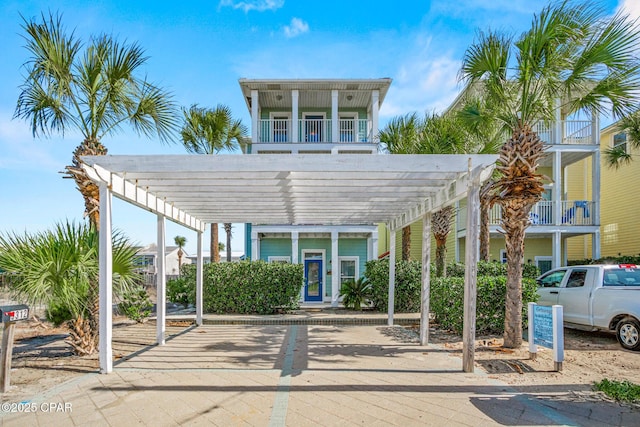 exterior space with a carport and a pergola