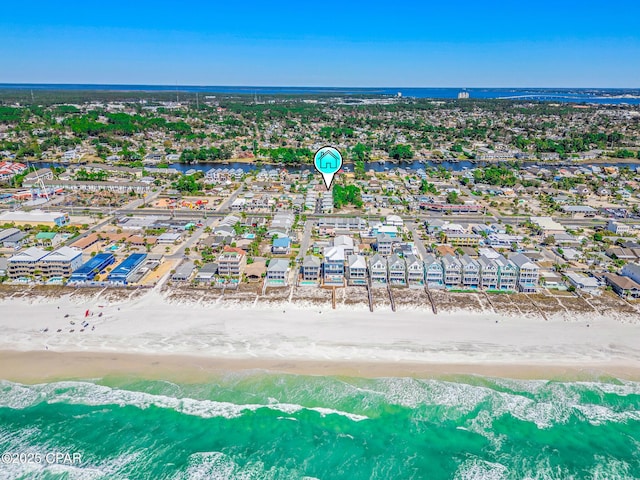 drone / aerial view featuring a residential view, a beach view, and a water view