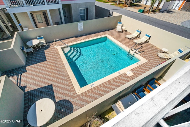 community pool featuring a patio area and fence