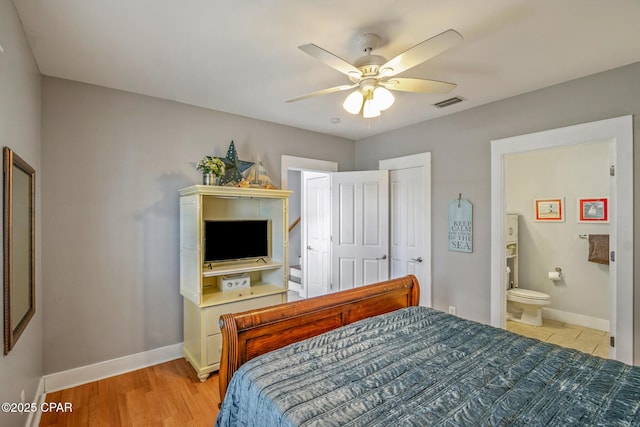 bedroom with visible vents, baseboards, ensuite bath, and ceiling fan