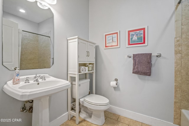 full bathroom featuring tile patterned floors, toilet, baseboards, and a tile shower