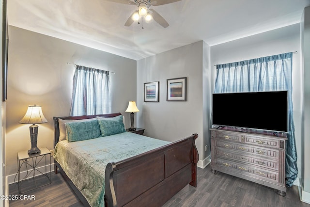 bedroom featuring a ceiling fan, baseboards, and wood finished floors