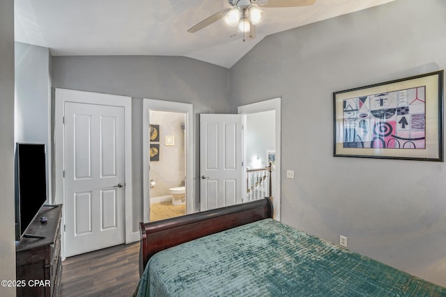 bedroom featuring vaulted ceiling, a ceiling fan, dark wood-style flooring, and connected bathroom