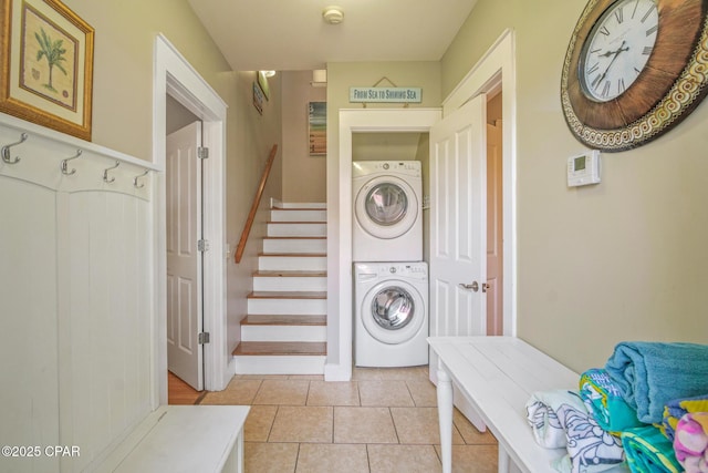 washroom featuring light tile patterned floors, laundry area, and stacked washer and dryer