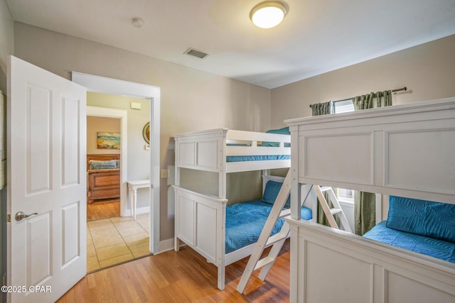 bedroom featuring light wood finished floors and visible vents