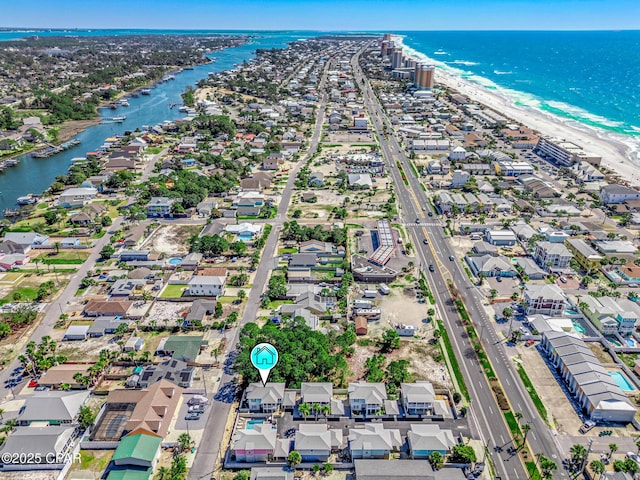 birds eye view of property with a beach view and a water view