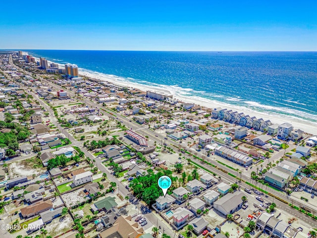 birds eye view of property with a water view and a beach view