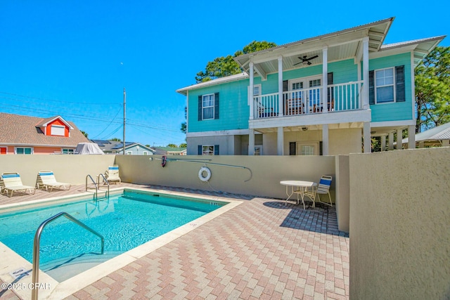 pool featuring a patio, ceiling fan, and fence