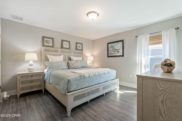 bedroom featuring wood finished floors, visible vents, and baseboards