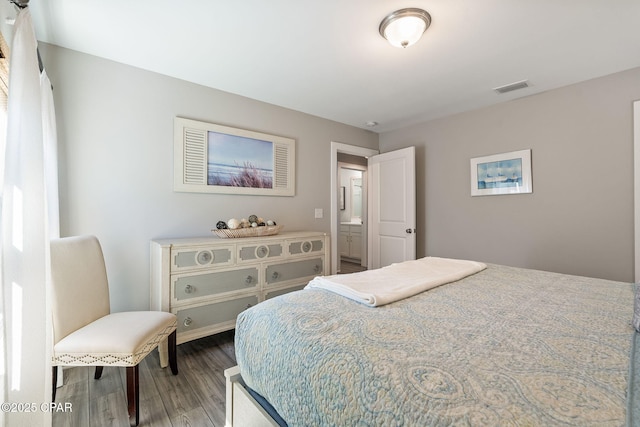 bedroom with wood finished floors and visible vents